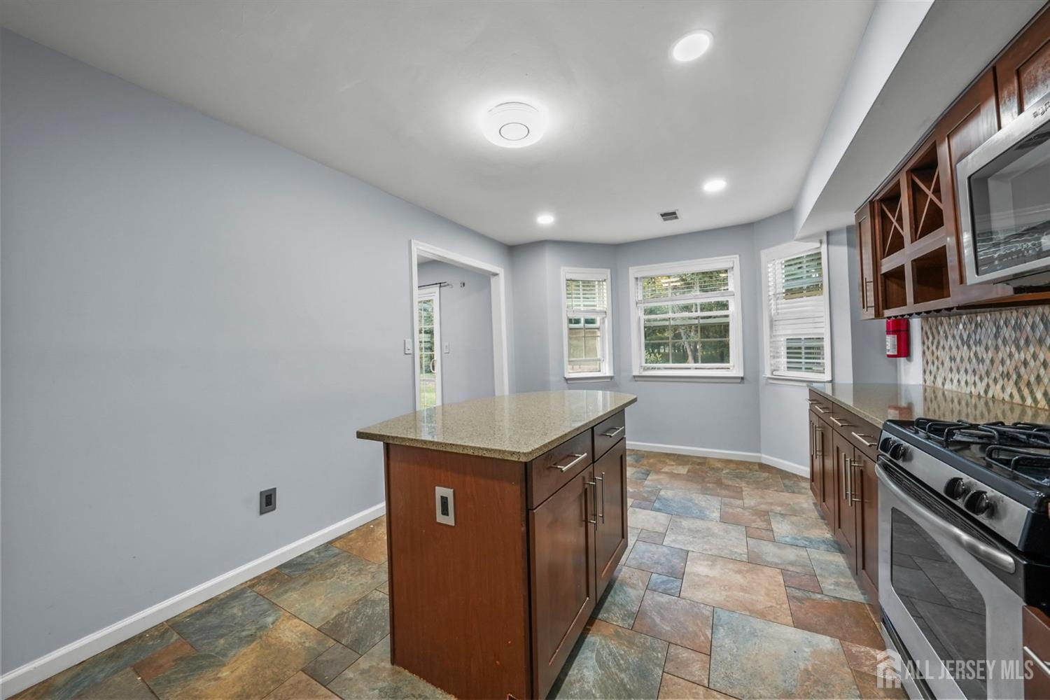 215 Nebula Road Piscataway, NJ 08854 - Photo 12 of 37 a kitchen with stainless steel appliances granite countertop a stove a sink and a refrigerator