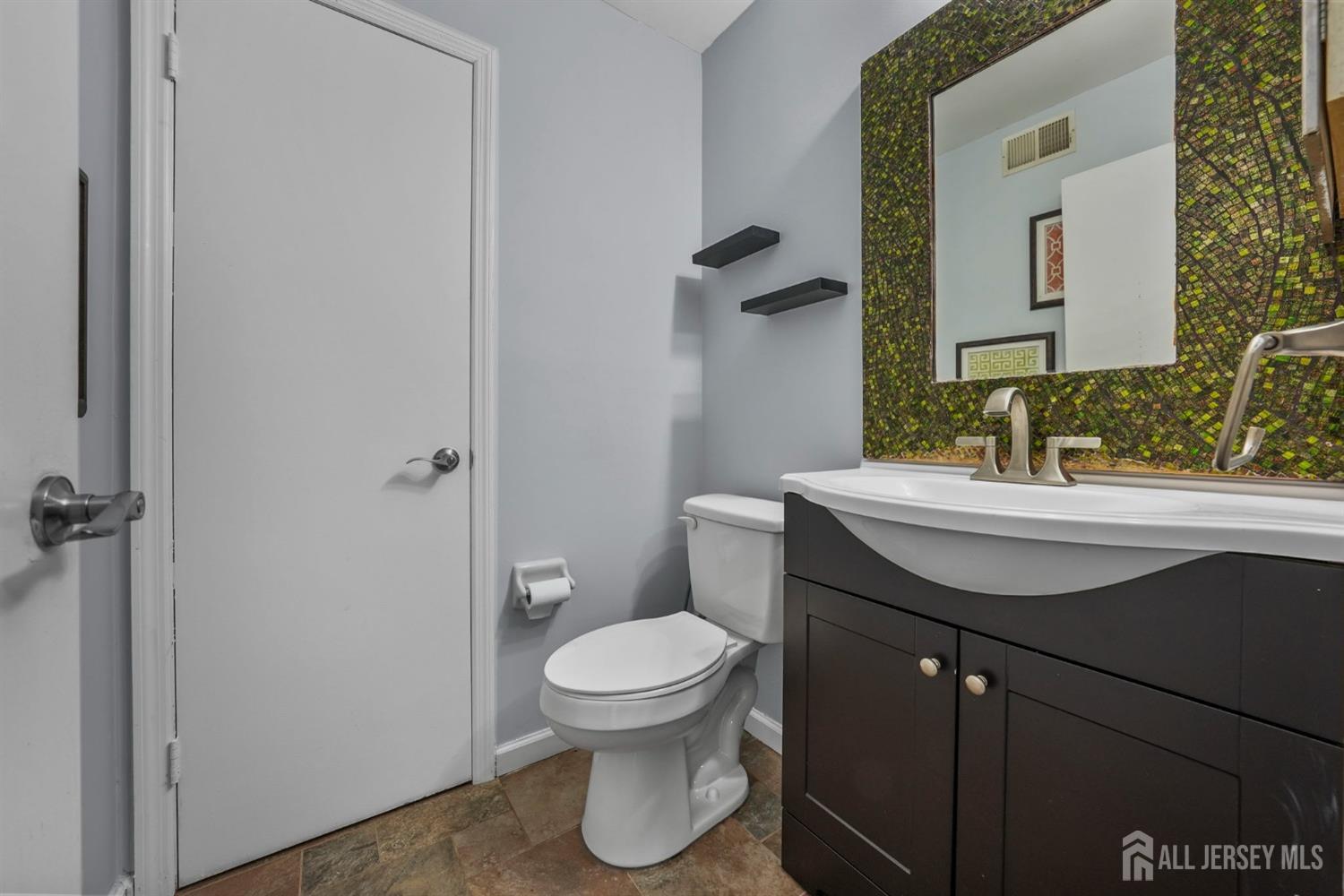 215 Nebula Road Piscataway, NJ 08854 - Photo 13 of 37 a bathroom with a sink toilet and mirror