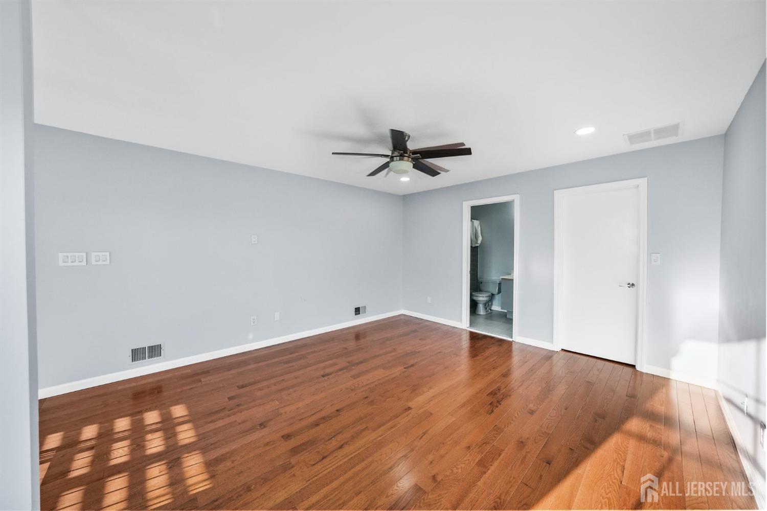 215 Nebula Road Piscataway, NJ 08854 - Photo 16 of 37 a view of a room with wooden floor and a ceiling fan