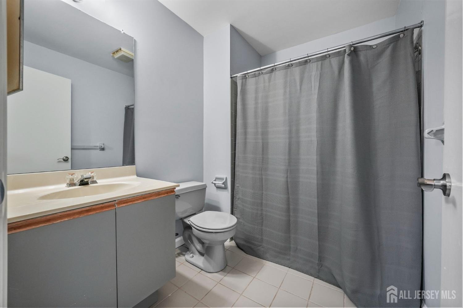215 Nebula Road Piscataway, NJ 08854 - Photo 17 of 37 a bathroom with a sink and a mirror