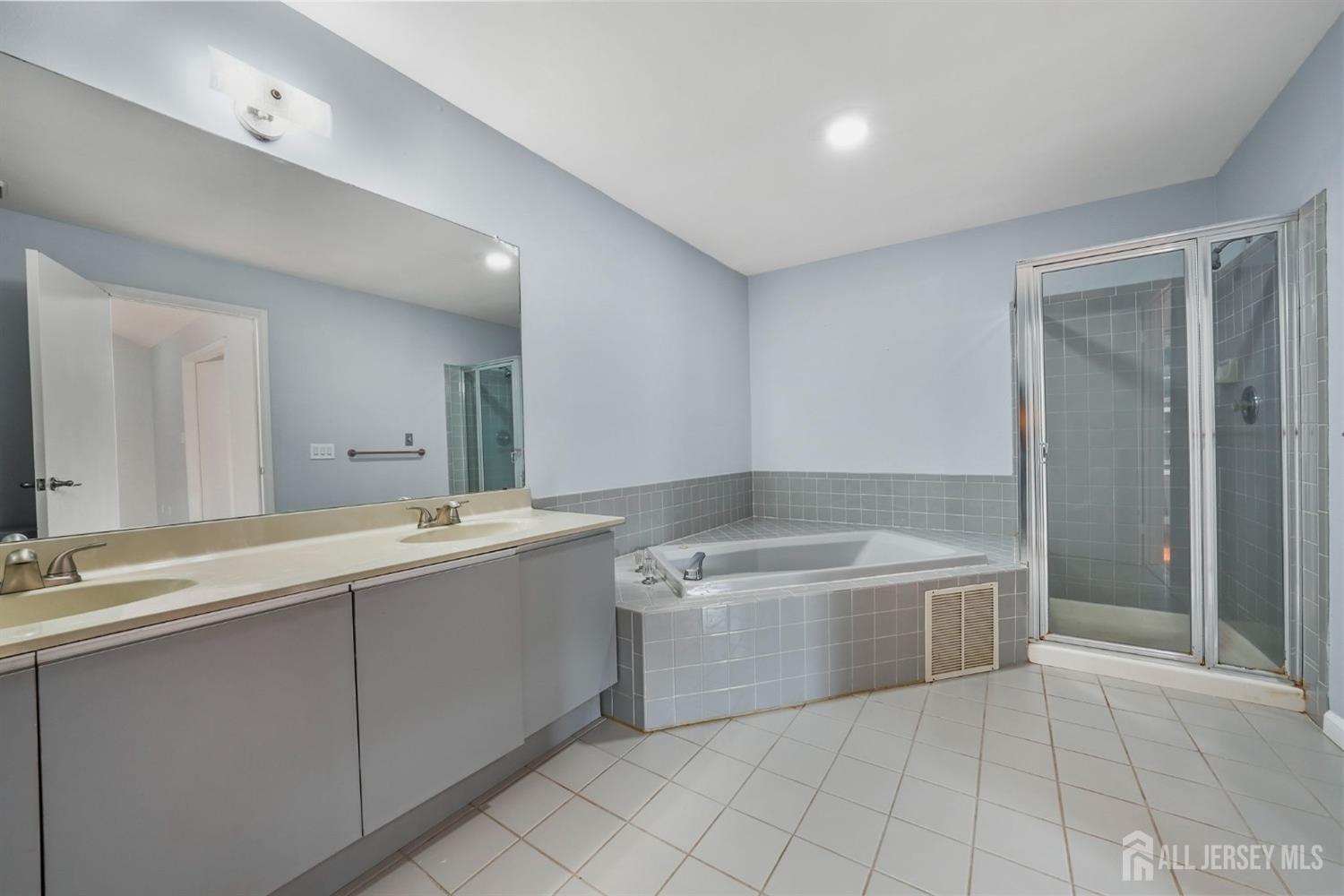 215 Nebula Road Piscataway, NJ 08854 - Photo 20 of 37 a bathroom with a tub sink and mirror
