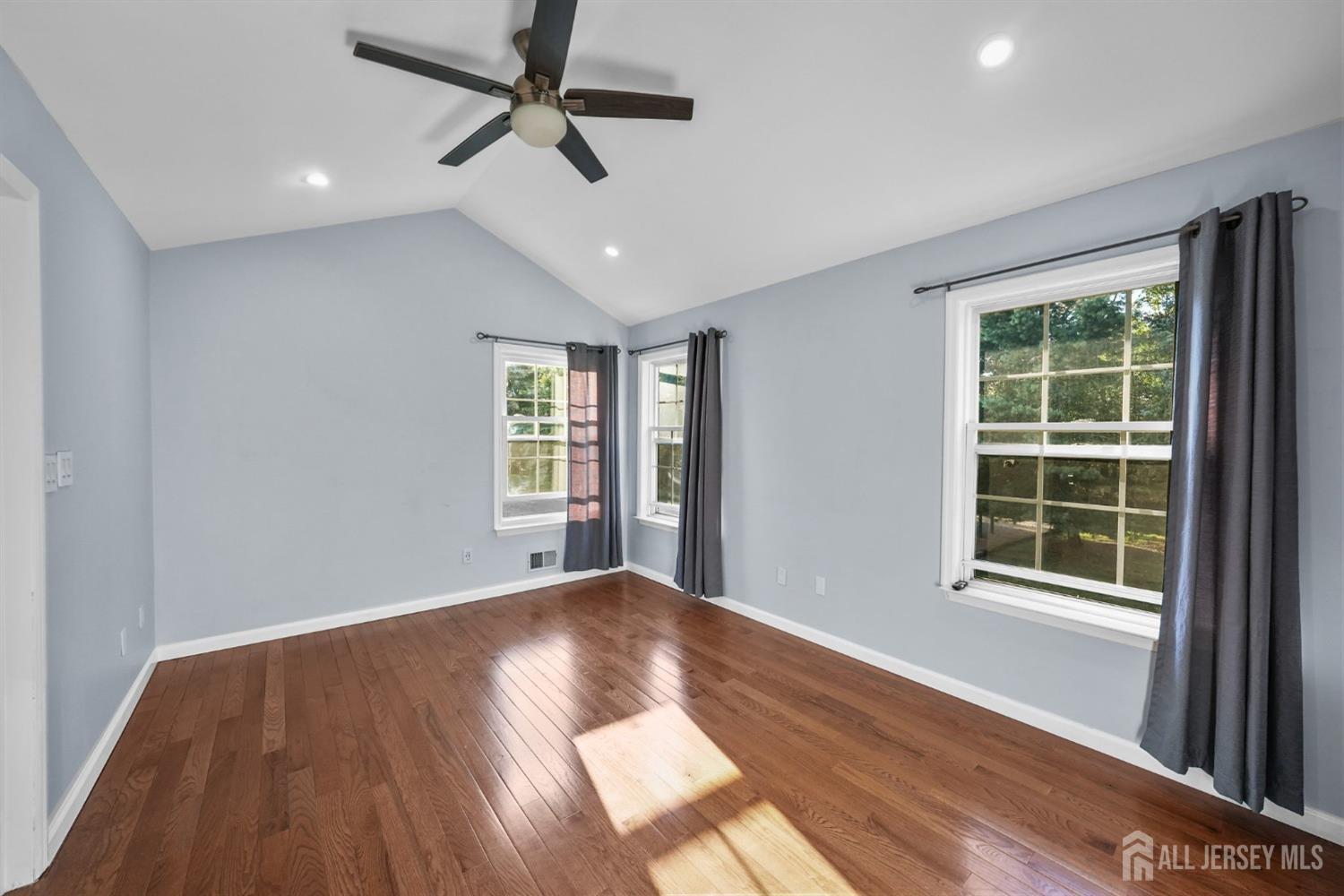 215 Nebula Road Piscataway, NJ 08854 - Photo 21 of 37 a view of an empty room with wooden floor and a window