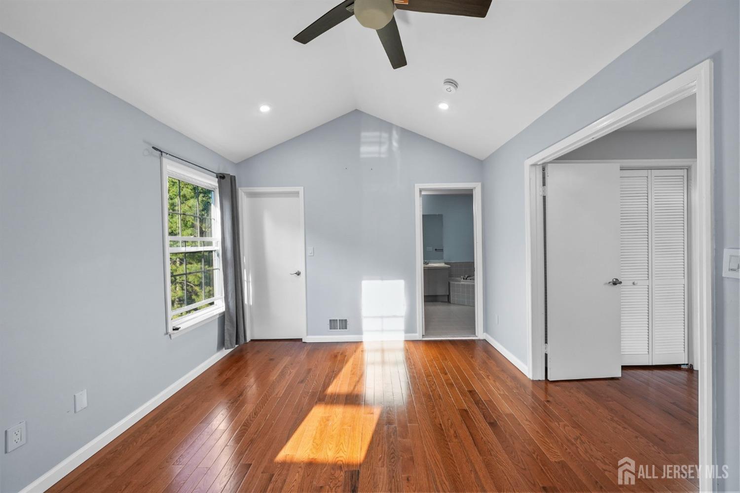 215 Nebula Road Piscataway, NJ 08854 - Photo 23 of 37 a view of an empty room with wooden floor and a window