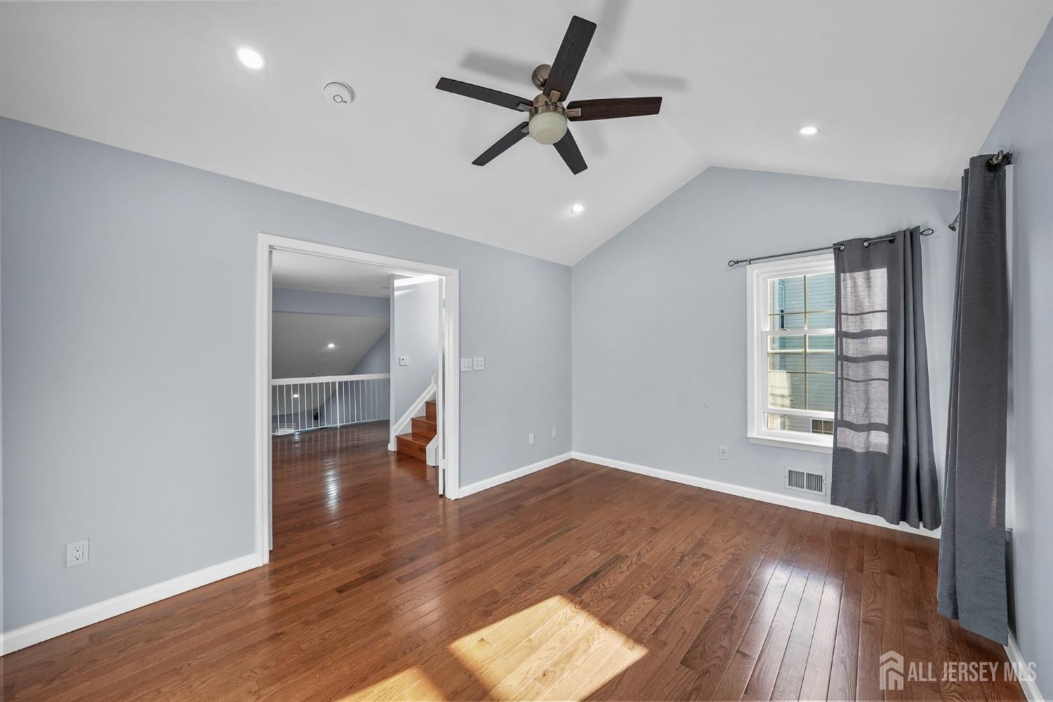215 Nebula Road Piscataway, NJ 08854 - Photo 24 of 37 a view of empty room with wooden floor and ceiling fan