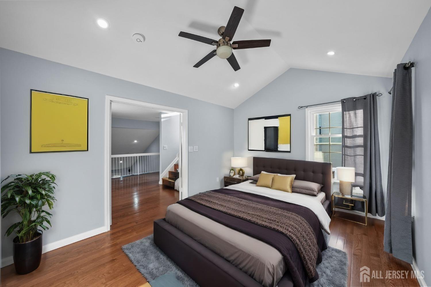 215 Nebula Road Piscataway, NJ 08854 - Photo 28 of 37 a bedroom with a bed and wooden floor