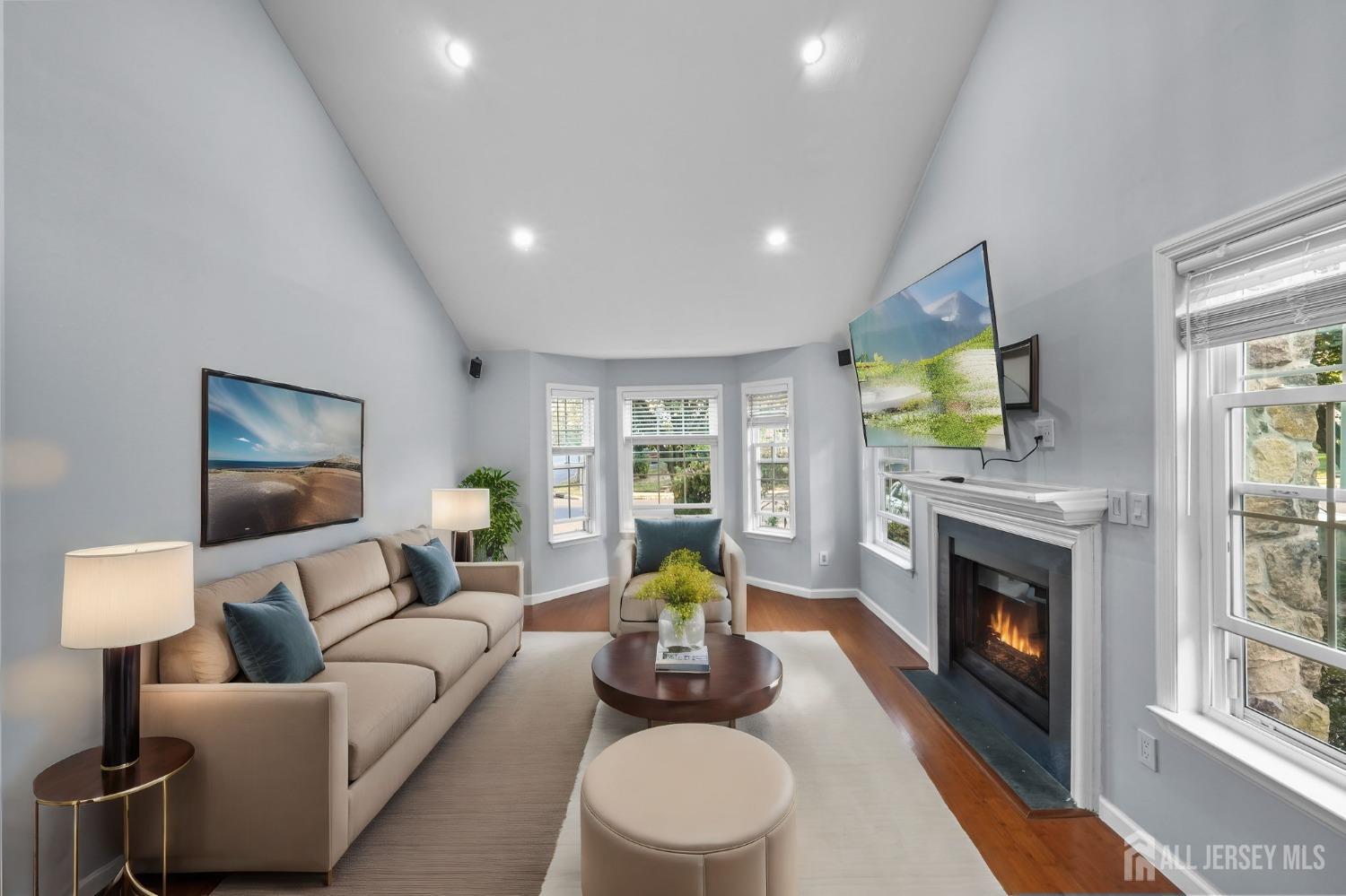 215 Nebula Road Piscataway, NJ 08854 - Photo 30 of 37 a living room with furniture a fireplace a flat screen tv and a large window