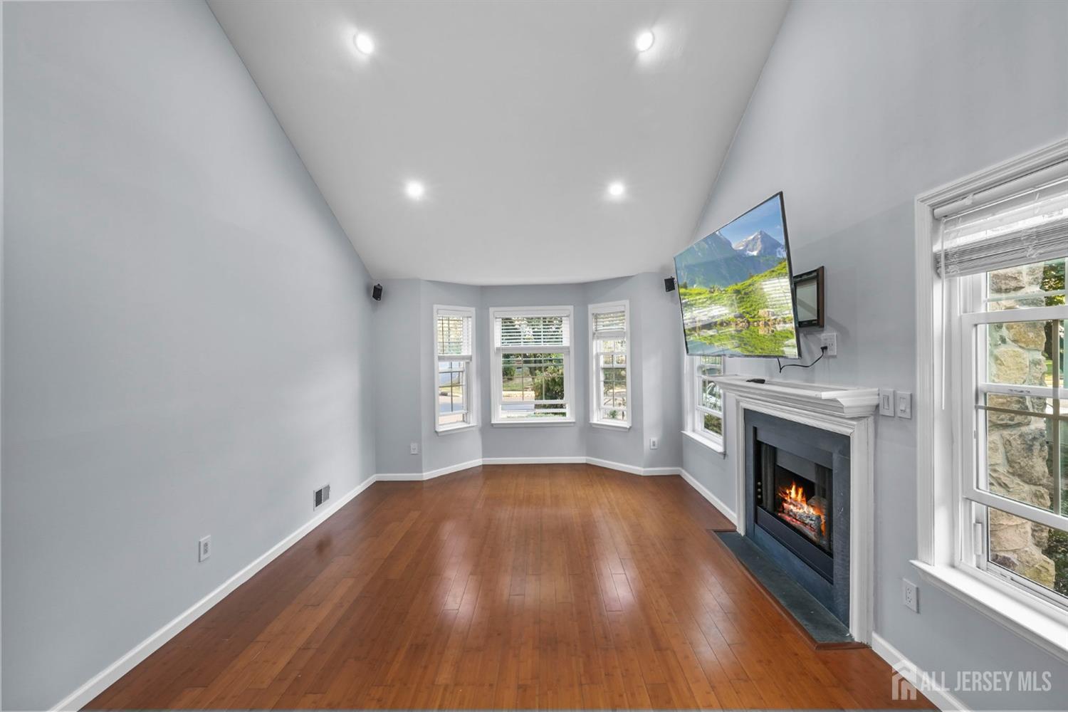 215 Nebula Road Piscataway, NJ 08854 - Photo 6 of 37 a view of an empty room with a fireplace and a window