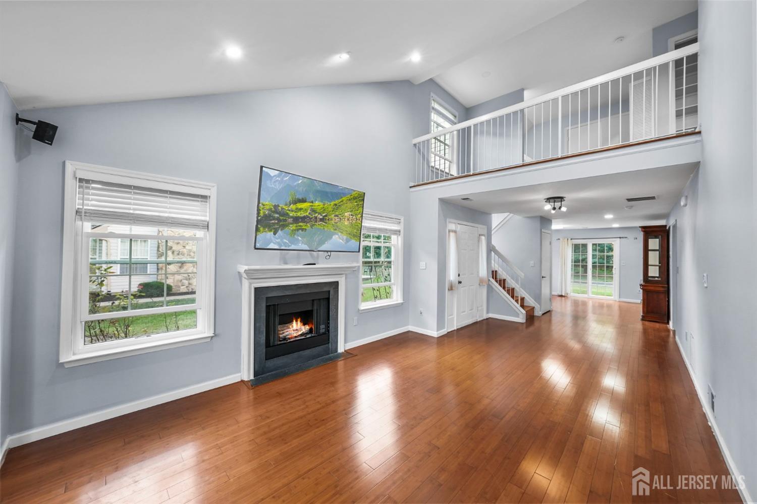215 Nebula Road Piscataway, NJ 08854 - Photo 7 of 37 a view of an empty room with wooden floor fireplace and a window