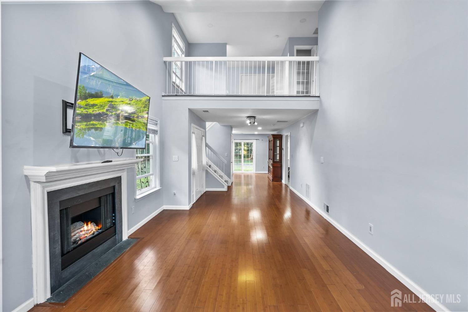 215 Nebula Road Piscataway, NJ 08854 - Photo 8 of 37 a view of empty room with wooden floor and fireplace