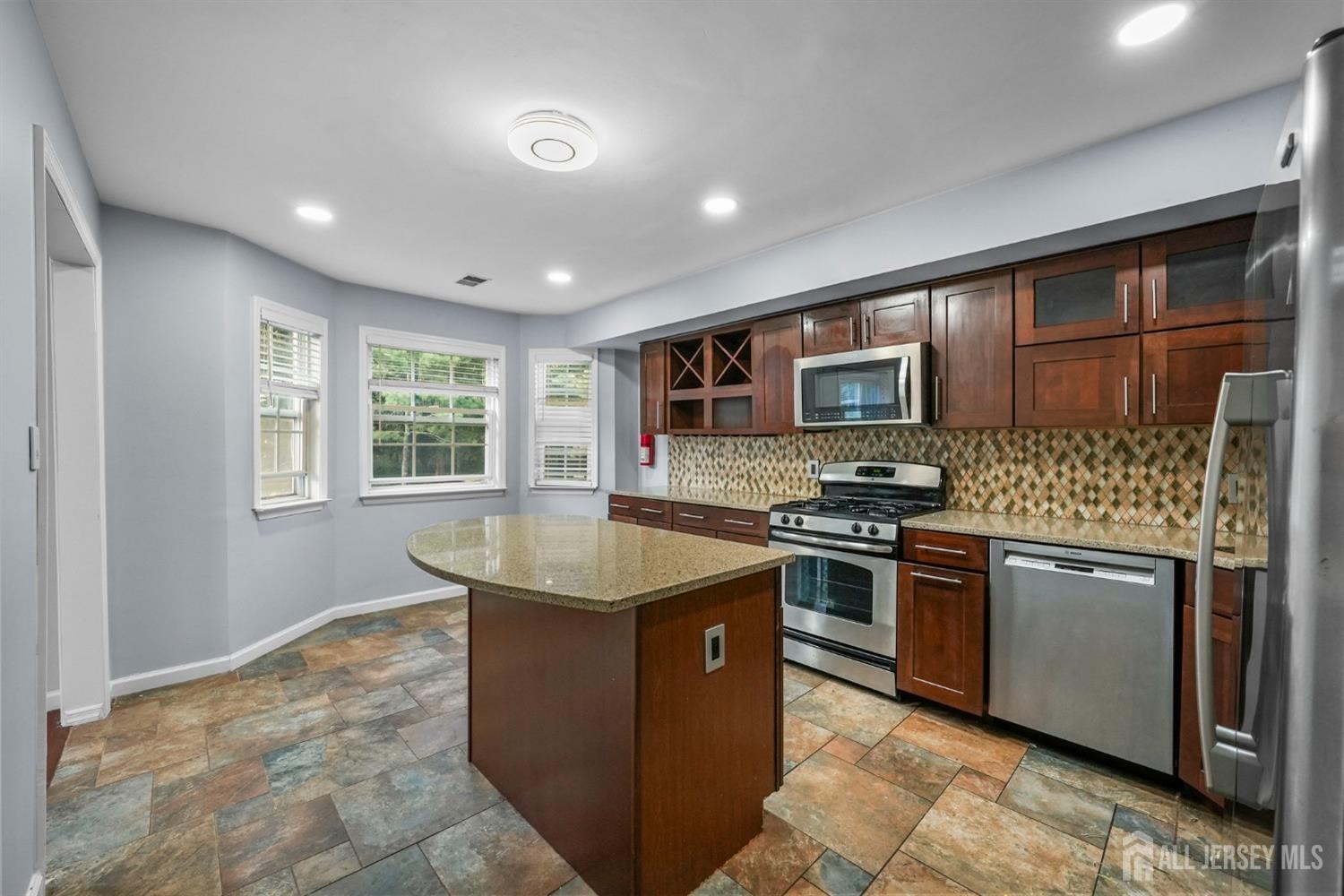 215 Nebula Road Piscataway, NJ 08854 - Photo 10 of 37 a kitchen with stainless steel appliances granite countertop a sink stove and refrigerator