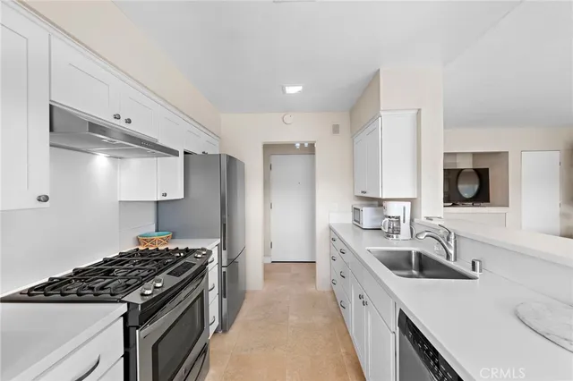 a kitchen with a sink stove top oven and refrigerator