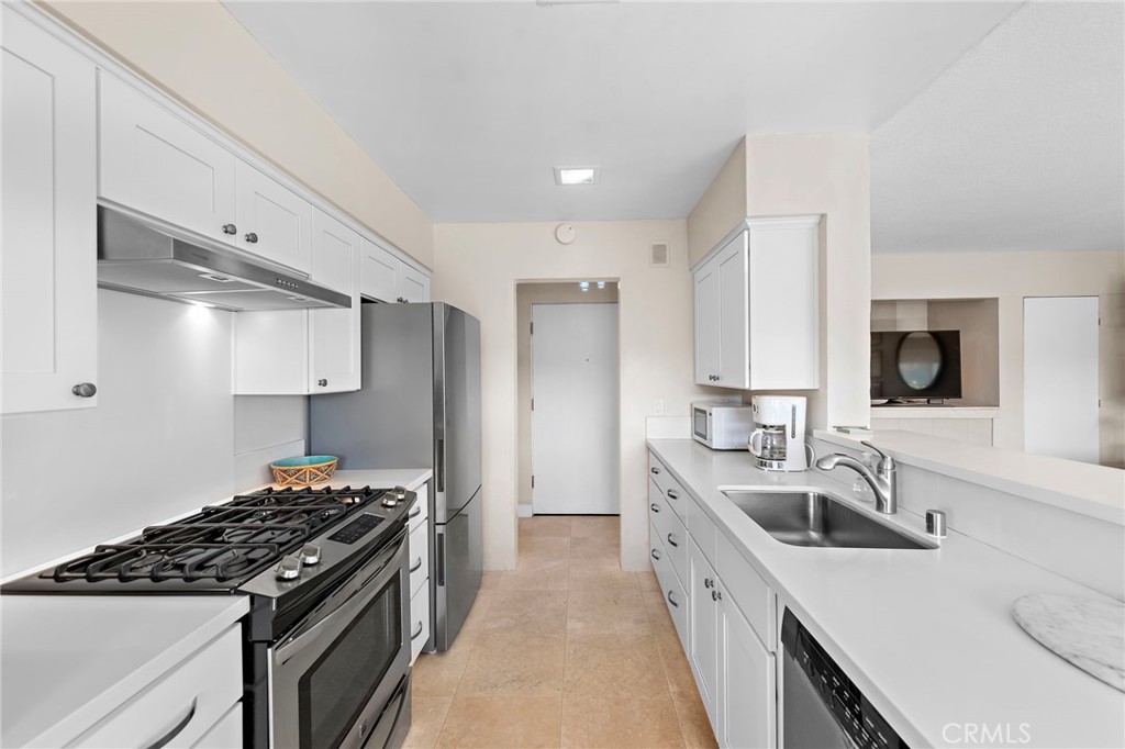 21703 Ocean Vista Drive, Unit 102 Laguna Beach, CA 92651 - Photo 13 of 19 a kitchen with a sink stove top oven and refrigerator