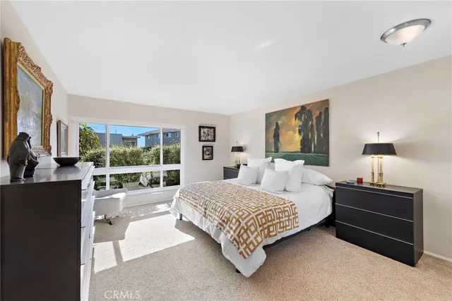 a bedroom with a bed and large window