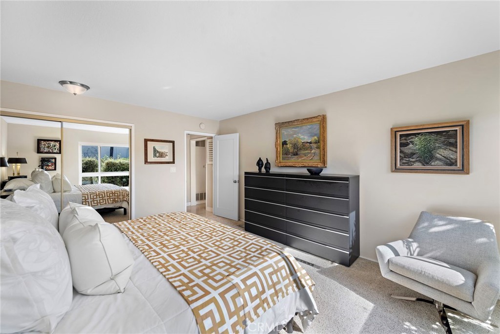 21703 Ocean Vista Drive, Unit 102 Laguna Beach, CA 92651 - Photo 16 of 19 a bedroom with a bed and wooden floor