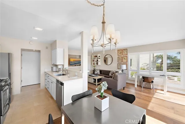 a large kitchen with a table chairs and a wooden floor