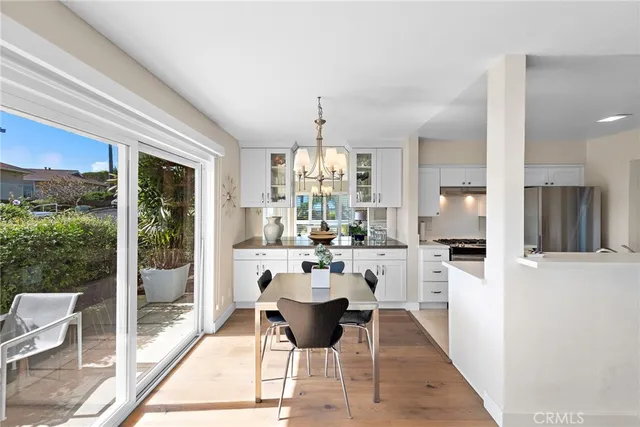 a kitchen with a table chairs refrigerator and cabinets