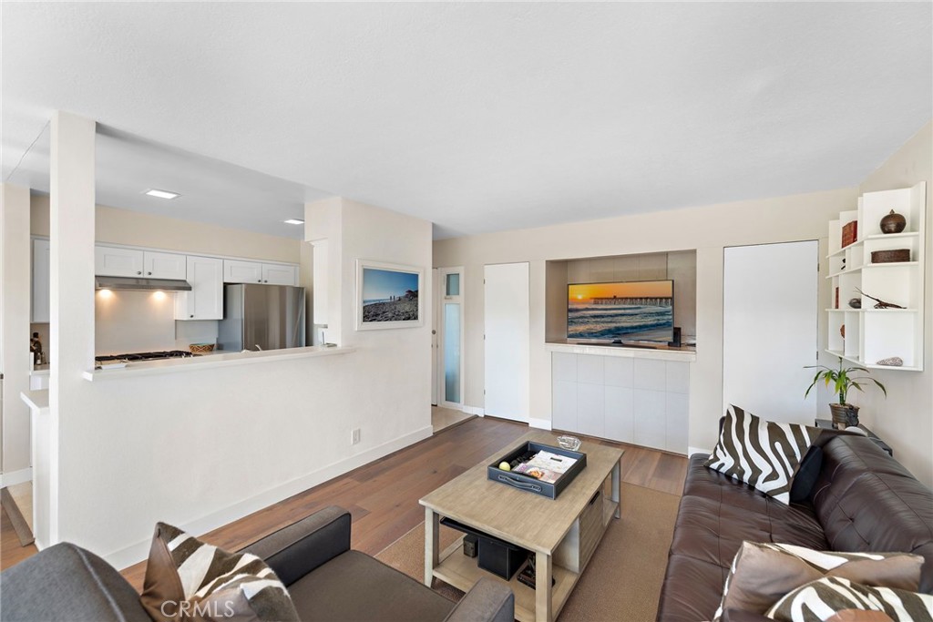 21703 Ocean Vista Drive, Unit 102 Laguna Beach, CA 92651 - Photo 8 of 19 a living room with furniture and a flat screen tv