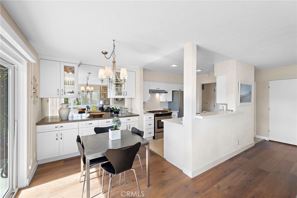 21703 Ocean Vista Drive, Unit 102 Laguna Beach, CA 92651 - Photo 10 of 19 a kitchen with stainless steel appliances kitchen island granite countertop a sink and cabinets