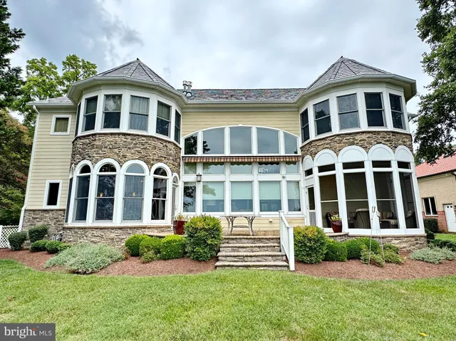 a view of a brick house with many windows
