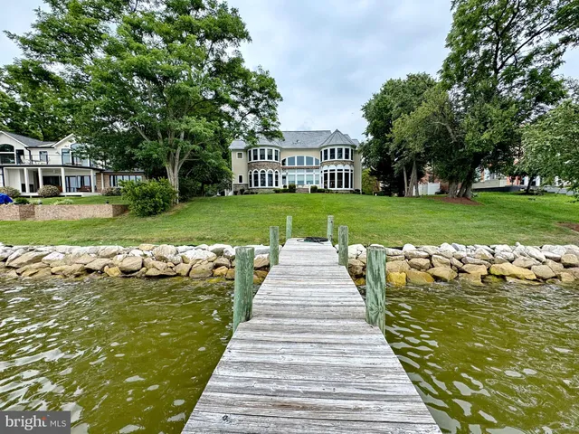 a dining room with furniture a chandelier and wooden floor