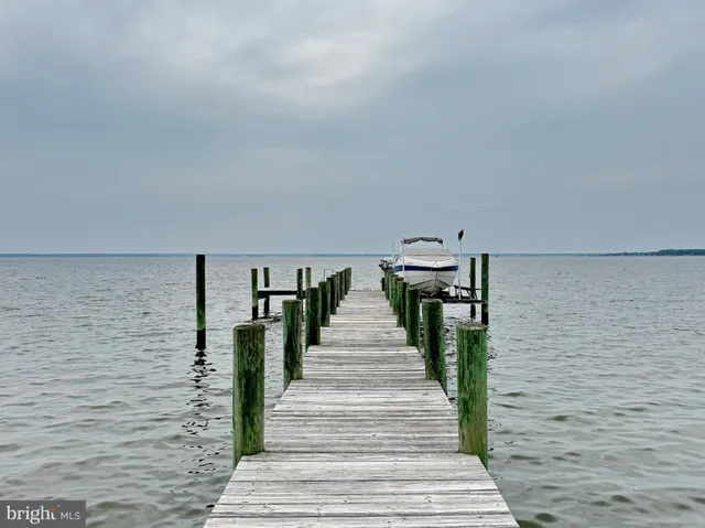 a living room with furniture large window and wooden floor
