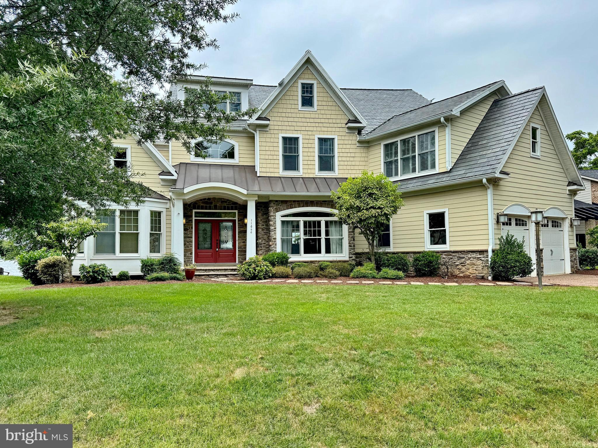 11660 Bachelors Hope Court Issue, MD 20645 - Photo 2 of 82 a front view of a house with a garden and porch