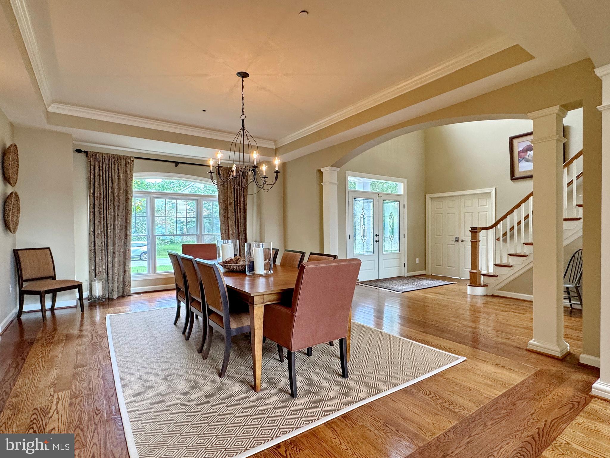 11660 Bachelors Hope Court Issue, MD 20645 - Photo 26 of 82 a dining room with furniture a chandelier and wooden floor