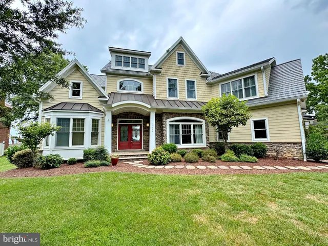 a front view of a house with a yard and porch