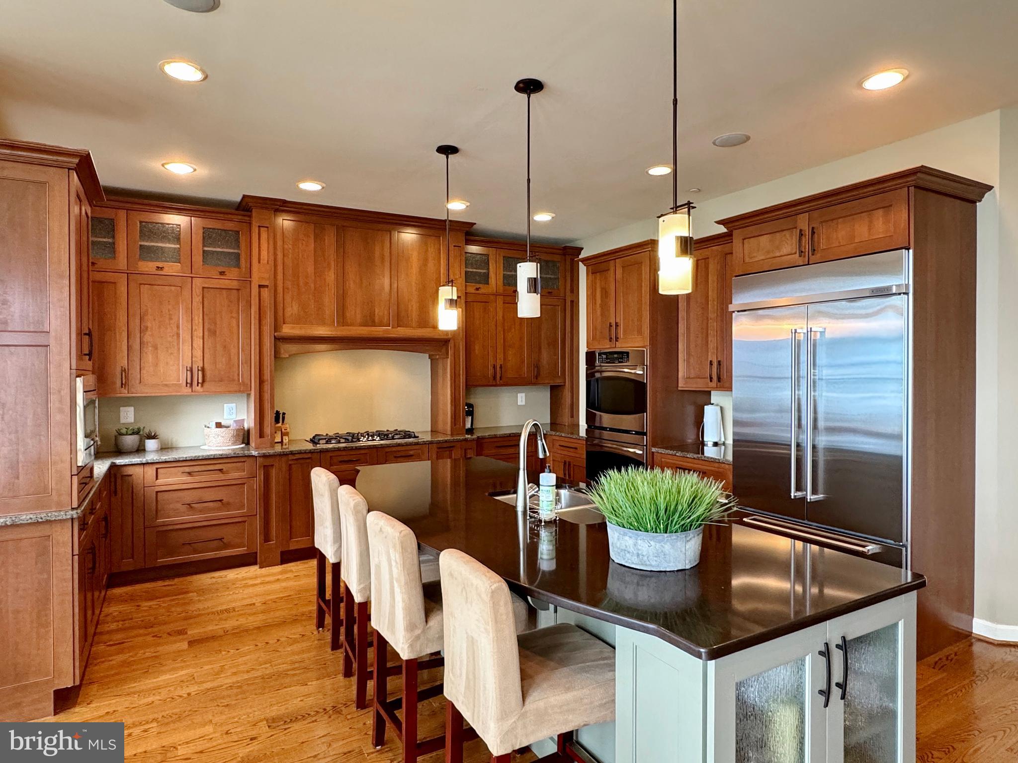 11660 Bachelors Hope Court Issue, MD 20645 - Photo 33 of 82 a kitchen with stainless steel appliances granite countertop sink stove top oven and cabinets