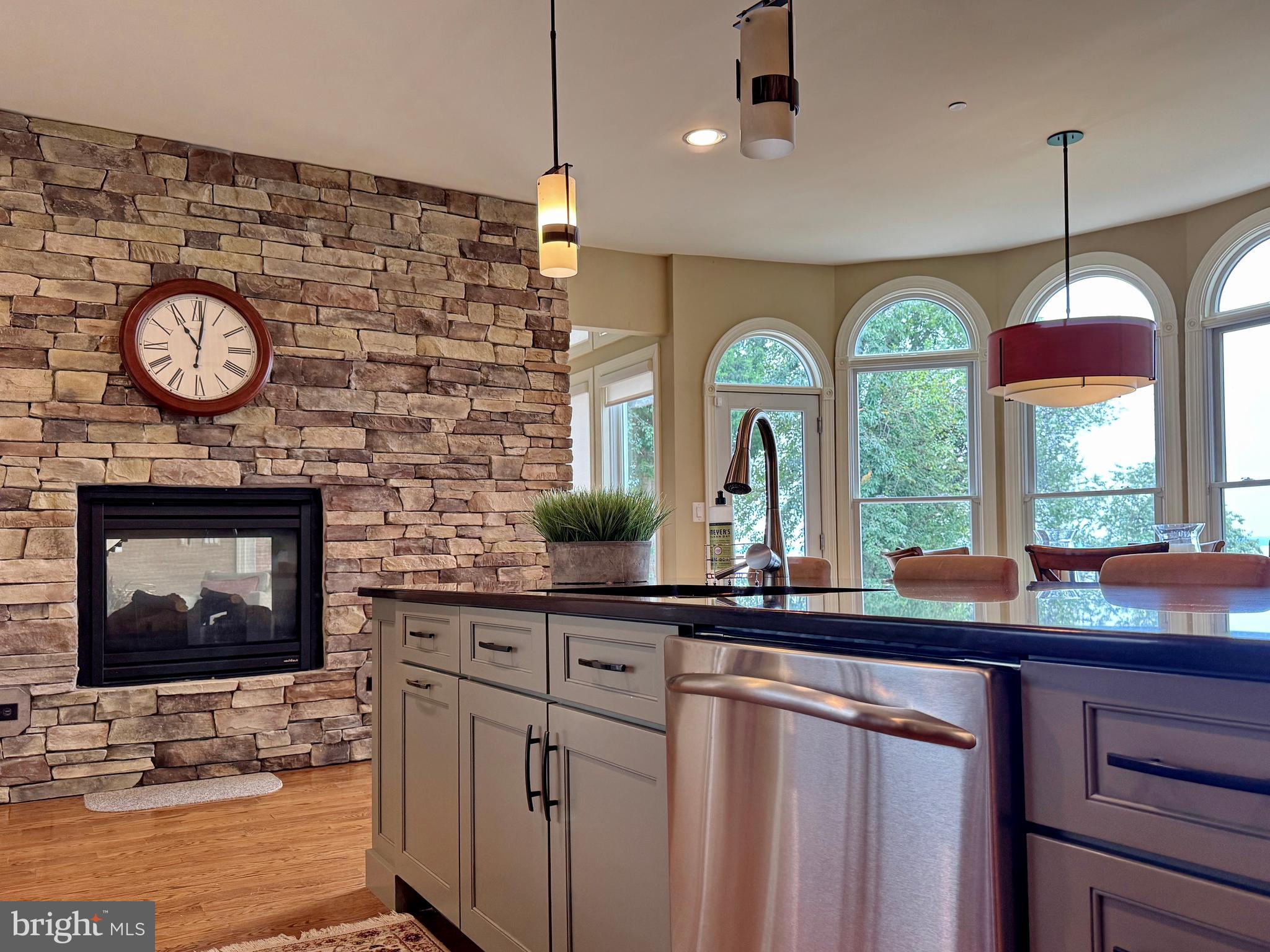 11660 Bachelors Hope Court Issue, MD 20645 - Photo 38 of 82 a kitchen with a large window and a clock on the wall
