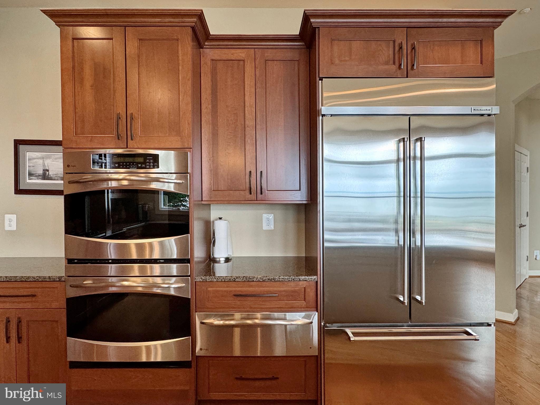 11660 Bachelors Hope Court Issue, MD 20645 - Photo 39 of 82 a kitchen with granite countertop a refrigerator and a stove