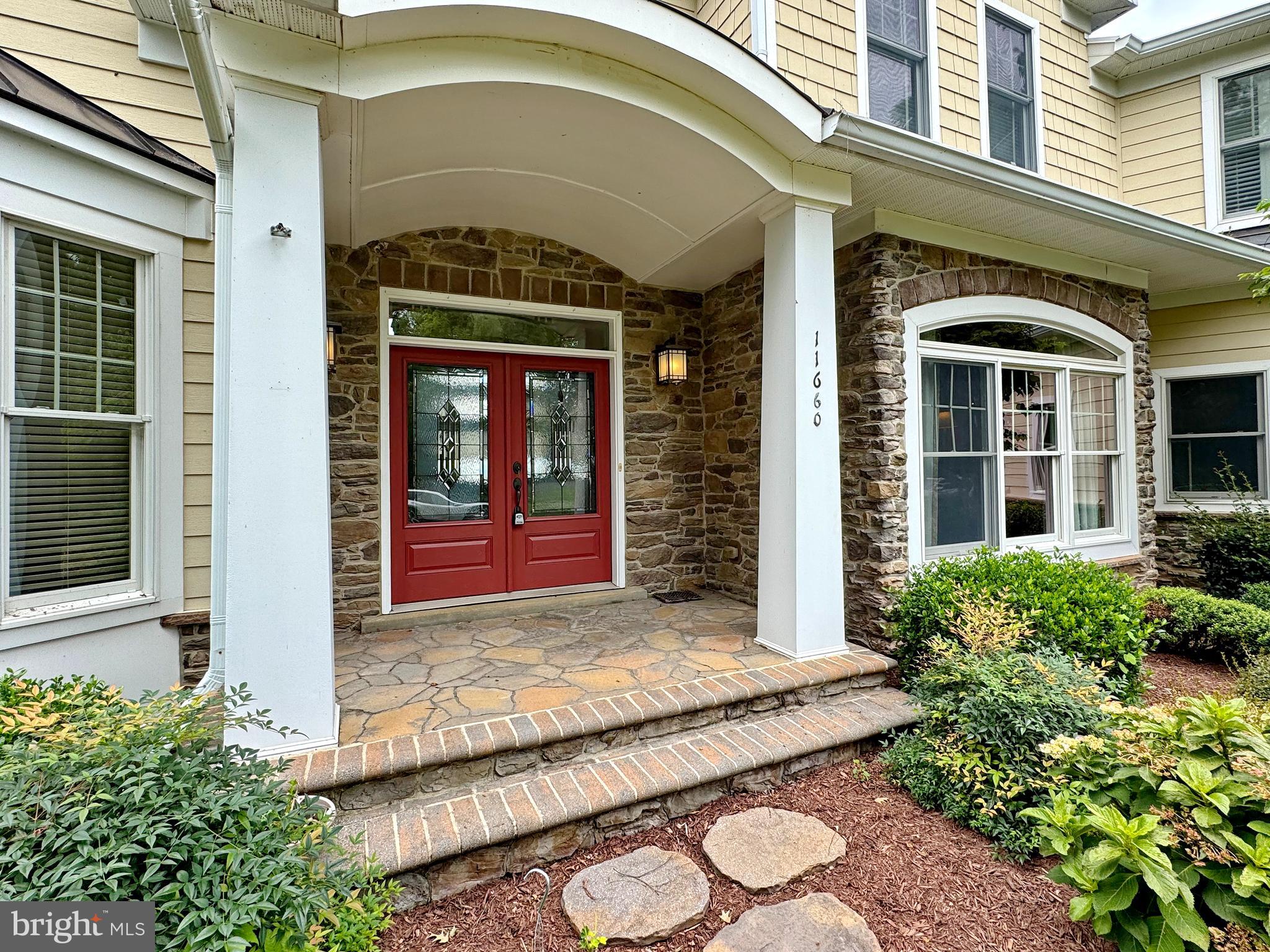 11660 Bachelors Hope Court Issue, MD 20645 - Photo 4 of 82 a view of a brick house with potted plants