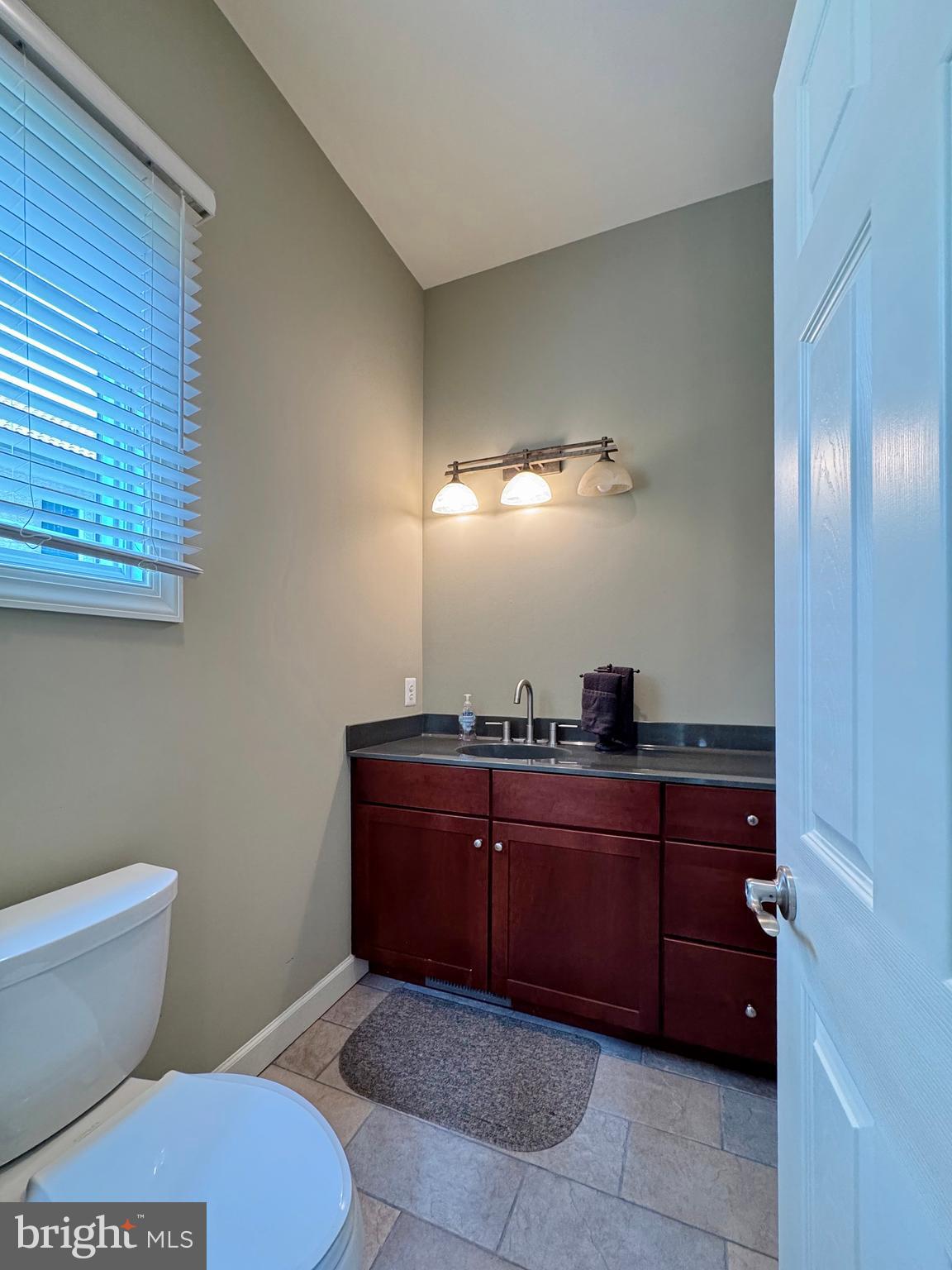 11660 Bachelors Hope Court Issue, MD 20645 - Photo 48 of 82 a bathroom with a sink and a mirror
