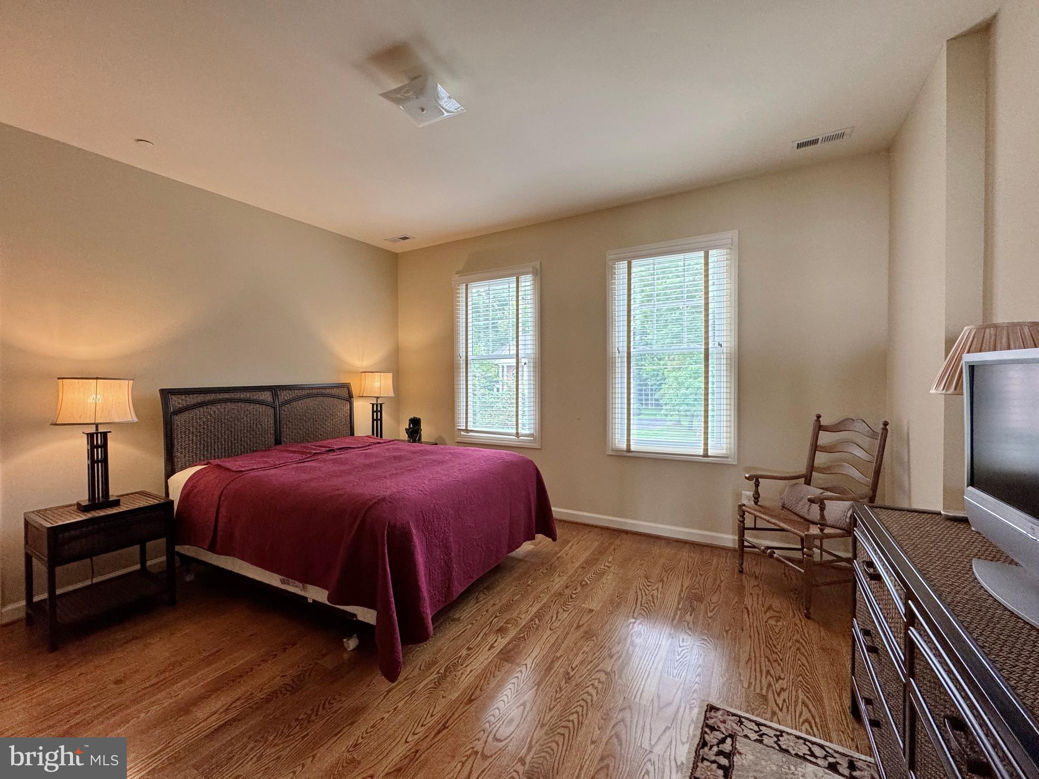 11660 Bachelors Hope Court Issue, MD 20645 - Photo 67 of 82 a spacious bedroom with a bed and wooden floor