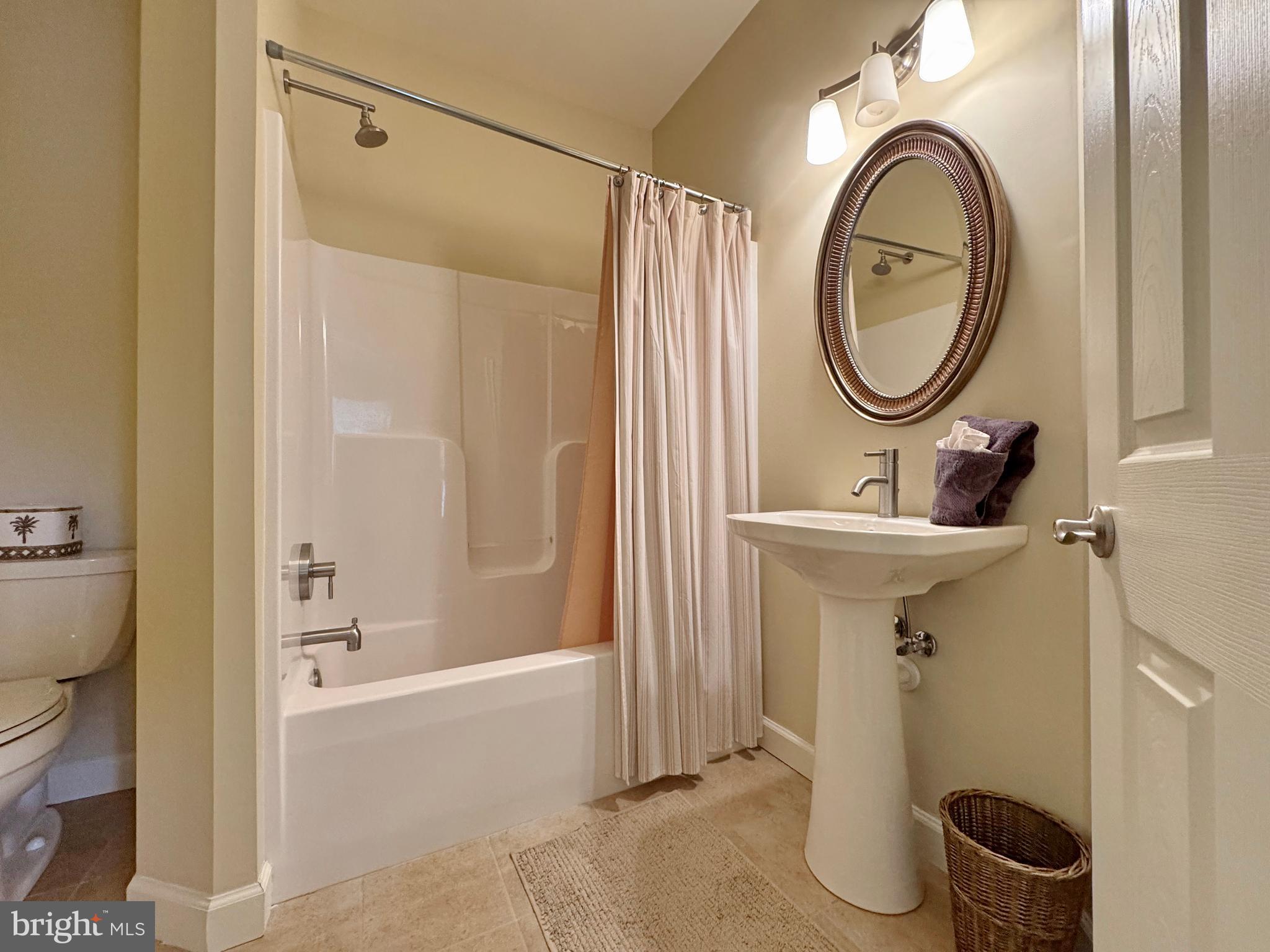 11660 Bachelors Hope Court Issue, MD 20645 - Photo 70 of 82 a bathroom with a sink a mirror a toilet and a shower