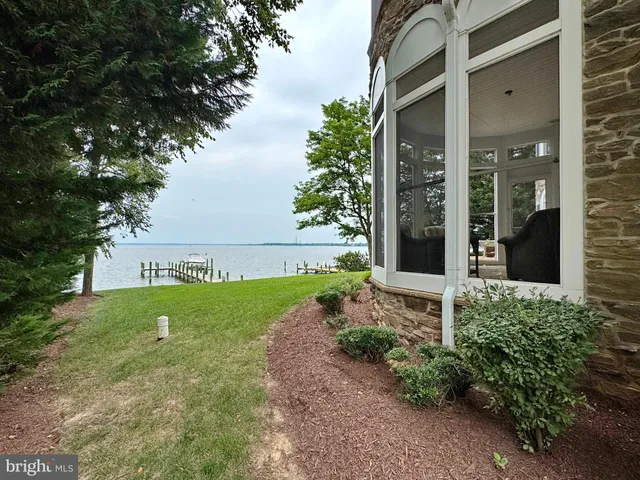 front view of a brick house with a yard
