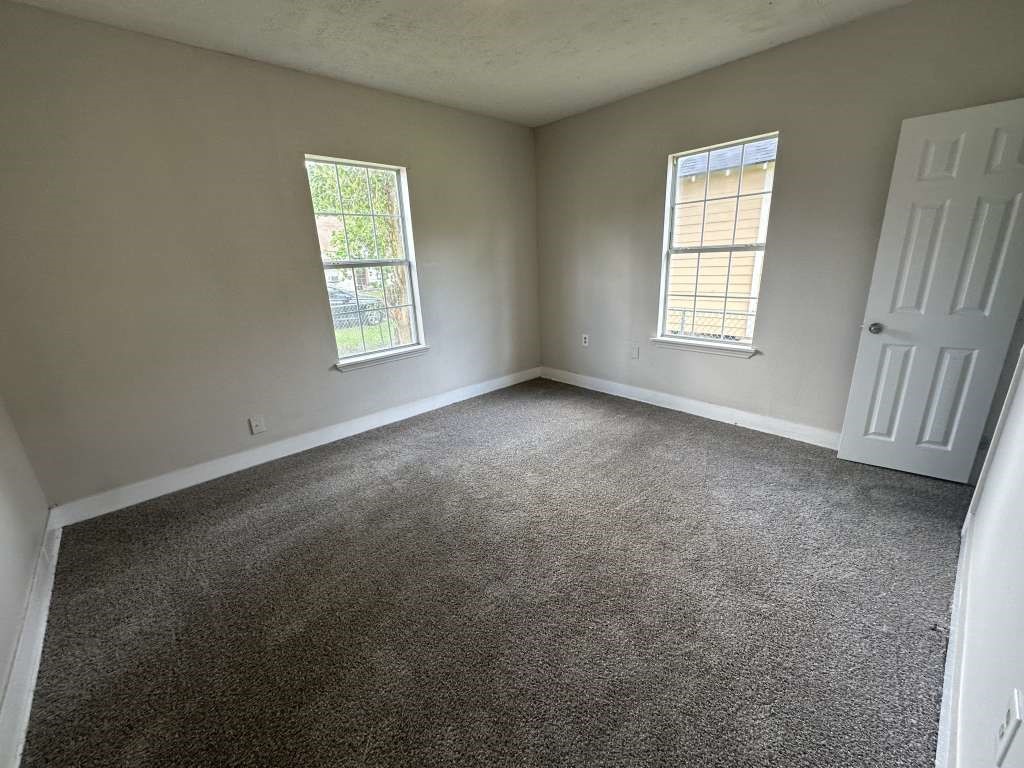 4520 Falls Street Houston, TX 77026 - Photo 9 of 11 an empty room with windows
