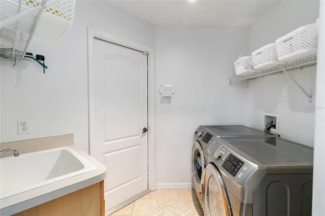 a bedroom that has a bed and a desk in it with window