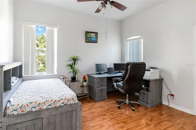 a bedroom with a bed and wooden floor
