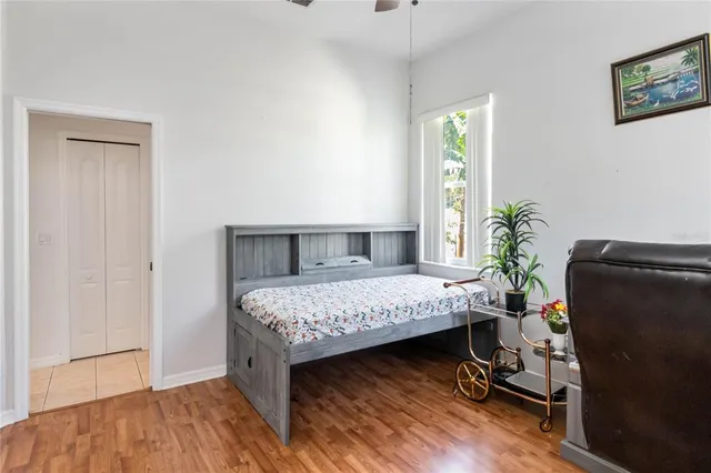 a bedroom with a bed dresser and a chandelier