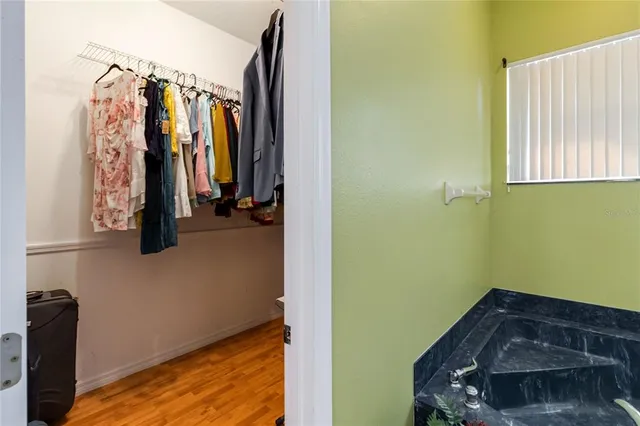 a view of entryway and hall with wooden floor