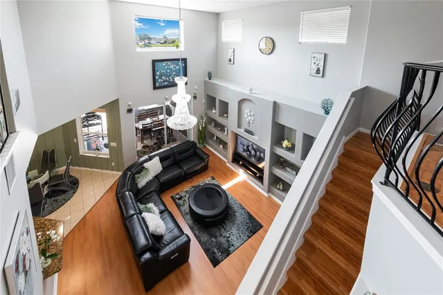 a view of staircase with a large mirror and wooden floor