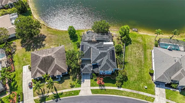 an aerial view of a house with a yard and potted plants