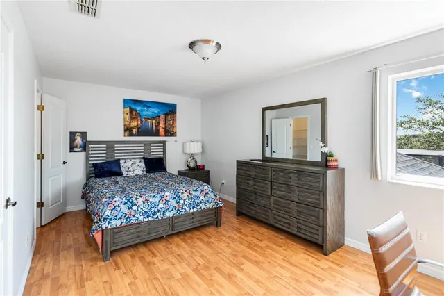 a bedroom with a bed and a chandelier