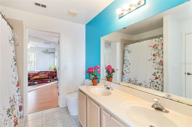 a bedroom with a bed mirror and a window