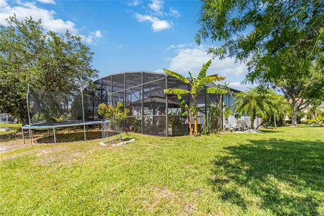 a view of a house with backyard and sitting area