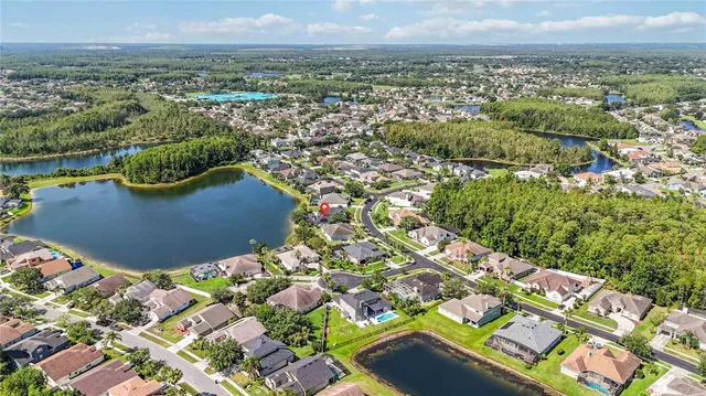 an aerial view of a house with outdoor space and lake view