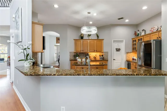 a kitchen with stainless steel appliances granite countertop a sink and cabinets