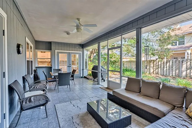 a living room with furniture and floor to ceiling windows
