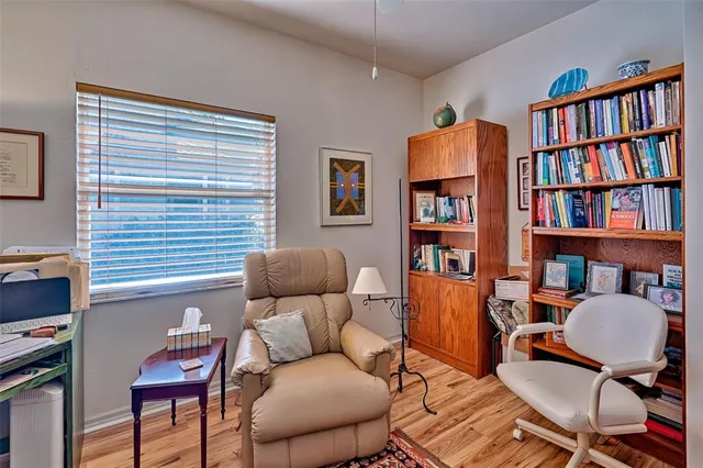 a living room with furniture and a book shelf